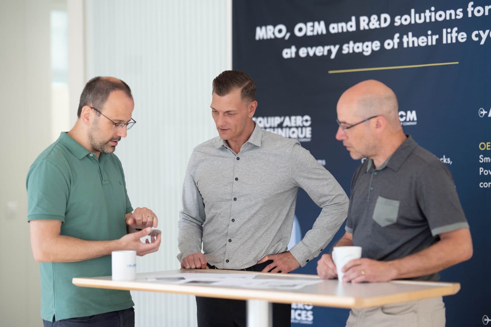 DOMUSA Group colleagues in discussion at a group stand