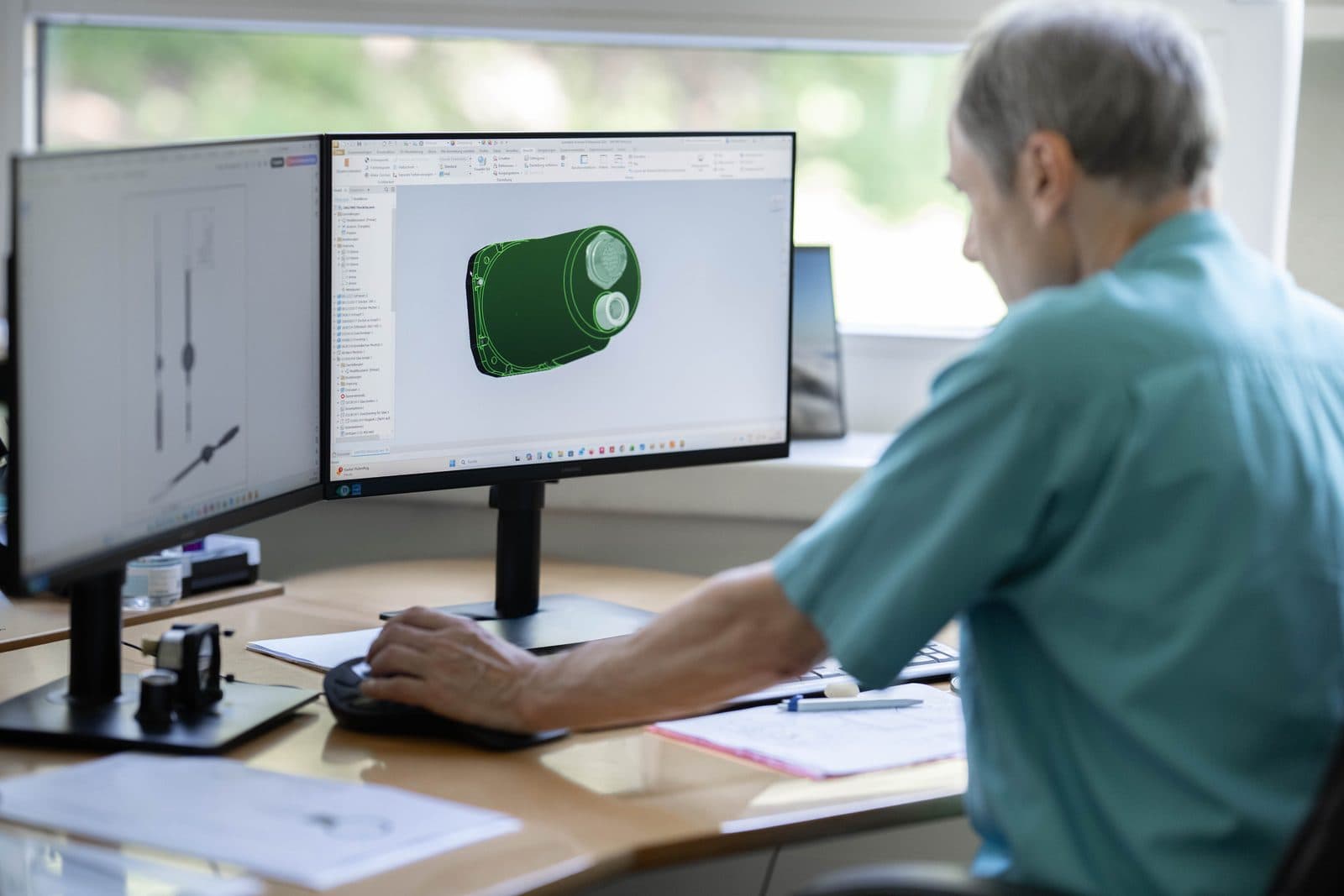 SATHOM engineer designing an instrument on a CAD workstation
